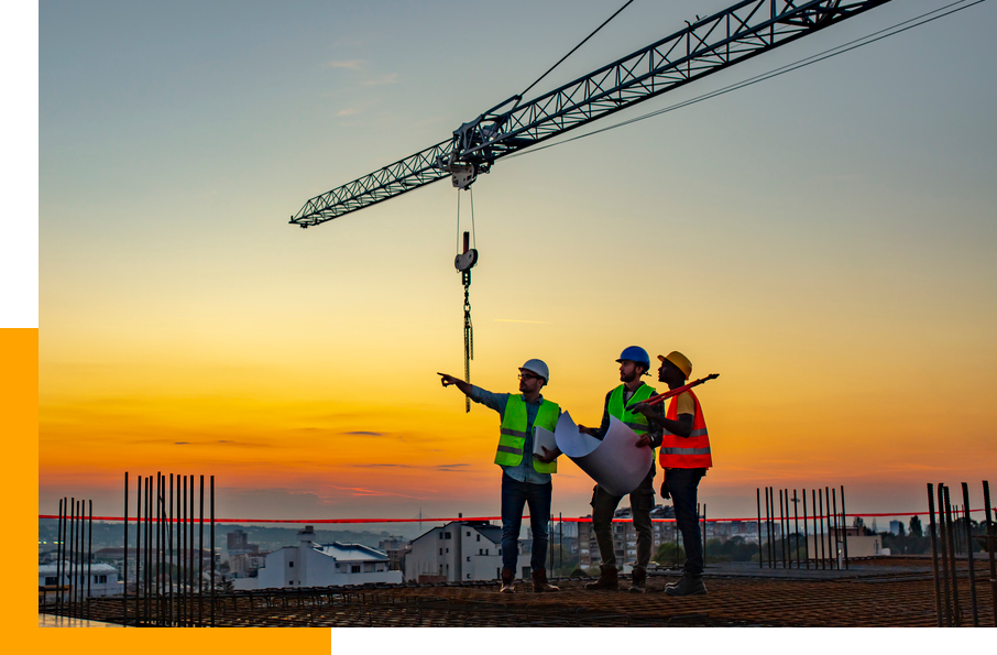 Construction workers in front of sunset